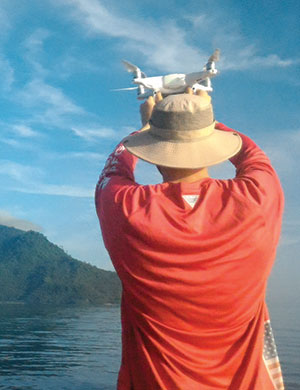 Ryan Mater prepares to launch an NMC drone in Indonesia's Bunaken National Park