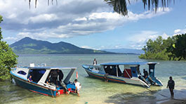 Boats prepare to depart for a day of surveying Bunaken National Park in Indonesia