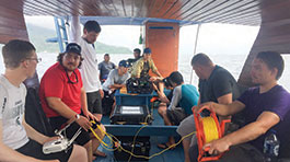 NMC students Ryan Mater and Clayton Harbin and Indonesian students preparing to send the ROV on a dive