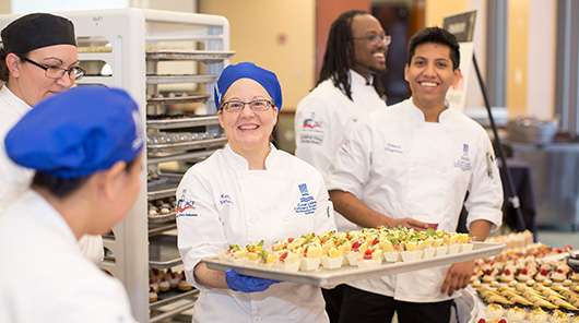 NMC culinary program students display trays of just-prepared hors d'oeuvres