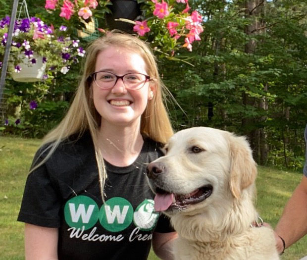 Megan smiling at the camera with her dog