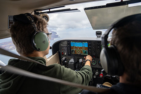 An Aviation program student pilots a plane over Grand Traverse Bay