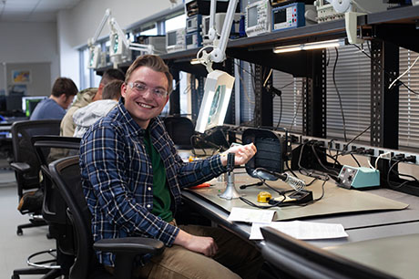 An Engineering Technology program student at a workbench