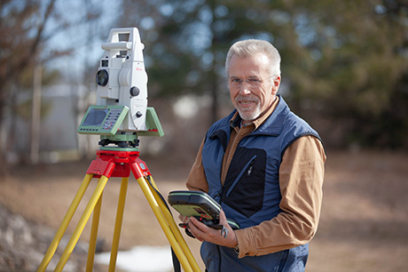 A Surveying program instructor with survey equipment