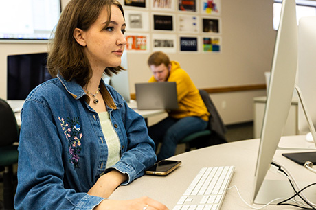 A Visual Communications program student works on a design on a computer