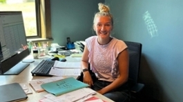 An NMC student works in an office during an internship