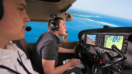 An NMC Aviation student and instructor fly over Grand Traverse Bay during a training flight