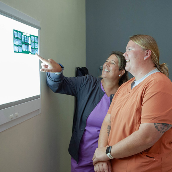 Dental Assistant program director Beckie Wooters and a student review dental x-rays