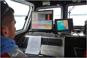 Alan Holcombe operates a multi-beam sonar system on Lake Superior