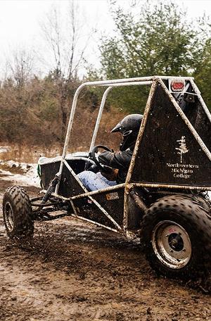 Engineering student Andy Sleder drives the NMC Blizzard Baja car in a practice round earlier this month.