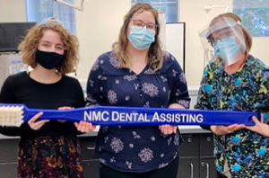 NMC dental assistant program students in protective gear