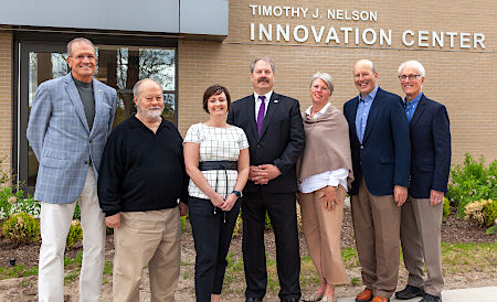 Photo of NMC board of trustees outside the Timothy J. Nelson Innovation Center