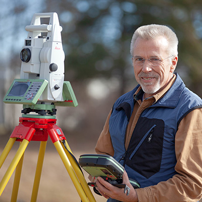 NMC Surveying Technology Program student Jim Schiffer uses a piece of surveying equipment in the field