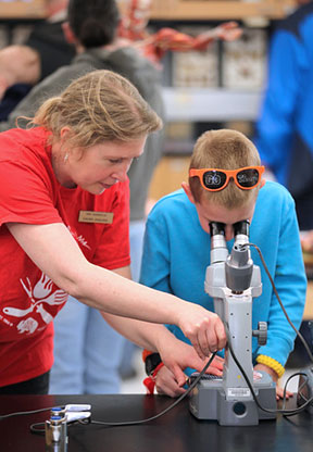 Laura Jaquish helps an NMC Barbecue attendee