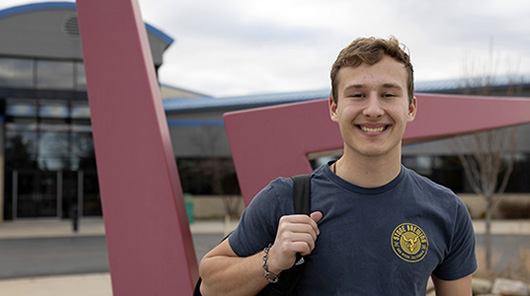 NMC student and Community College Guarantee recipient Luke Bobrowski outside the Parsons-Stulen Building