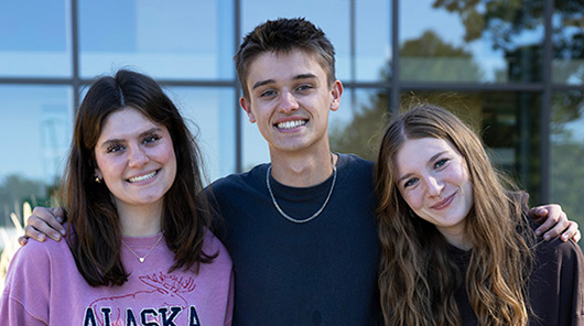 Early college students standing in front of the Timothy J. Nelson Innovation Center