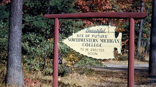 A wooden sign from 1952 pointing to the future site for NMC