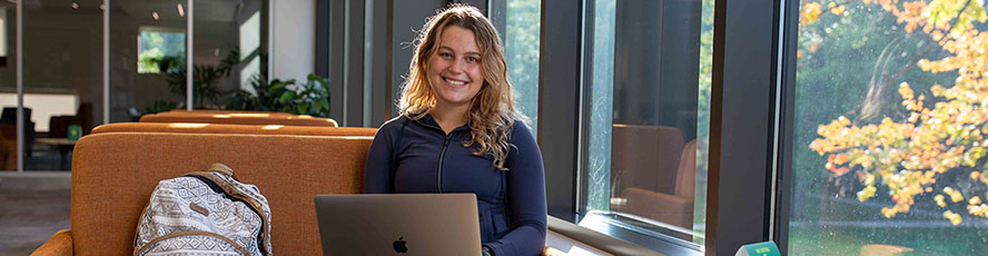 A smiling NMC student inside the Timothy J. Nelson Innovation Center on NM's Front Street campus