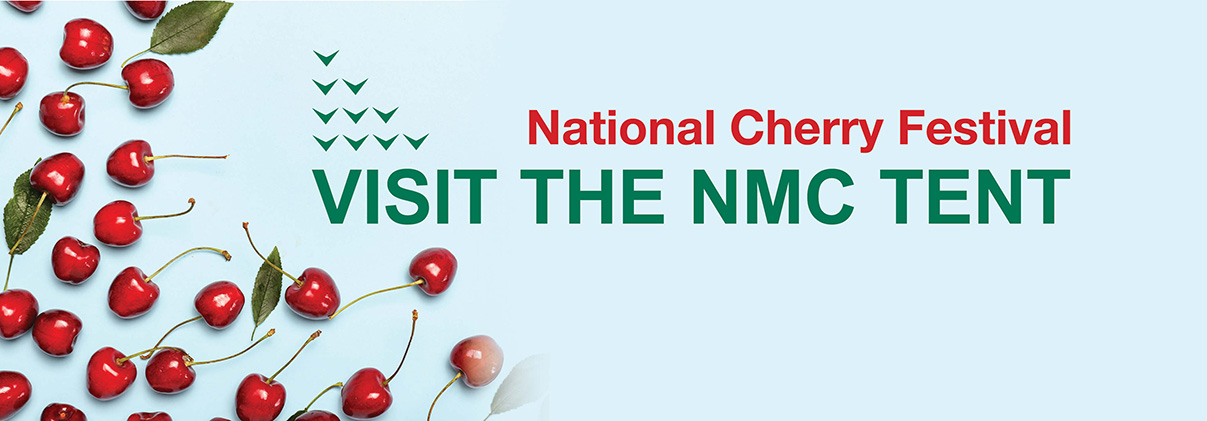 Cherries on their stems and a message to visit the NMC tent during Cherry Festival