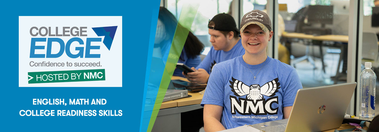 A smiling NMC student wearing a hawk owl t-shirt sits in front of her laptop in a study room