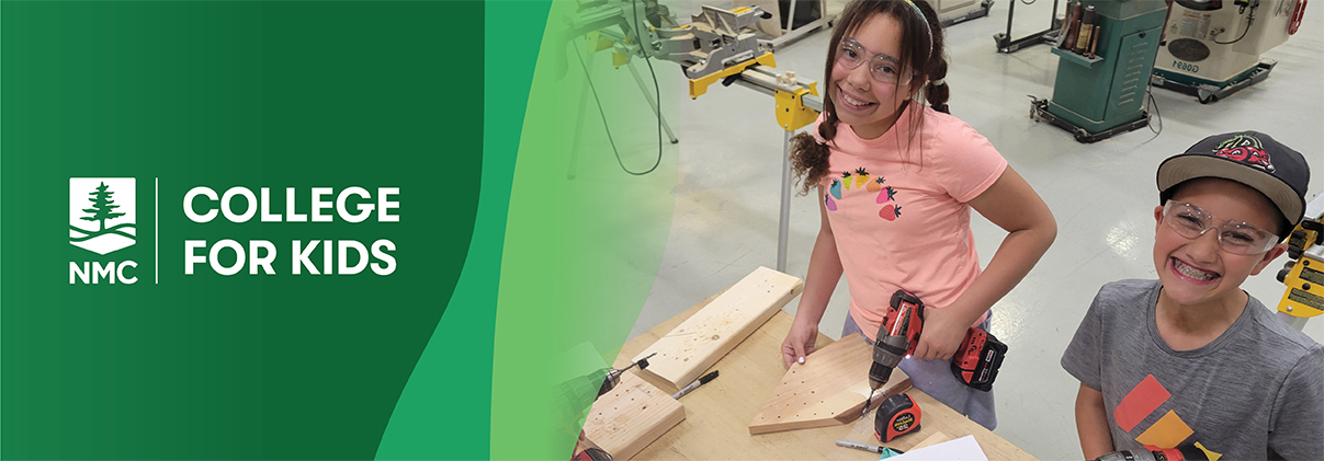 A smiling girl working on a woodworking project with a power drill