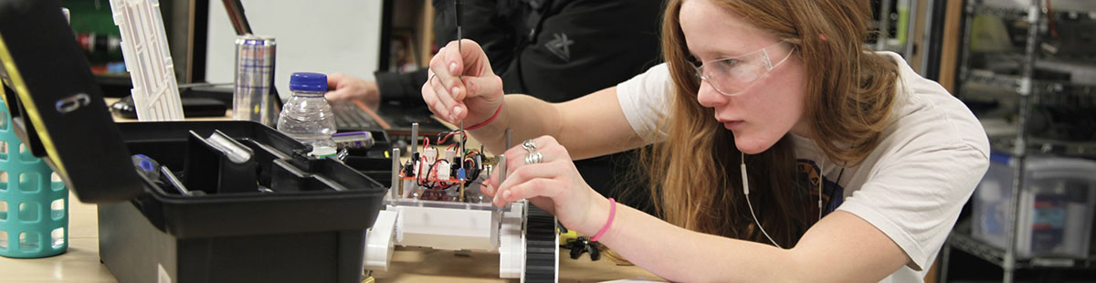 An NMC Engineering Technology Program student wiring a remotely operated vehicle (ROV)