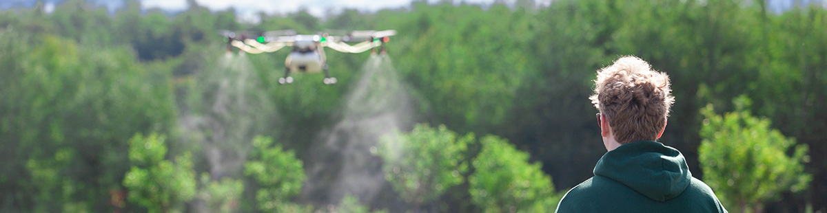 An NMC UAS program student controls an agricultural drone