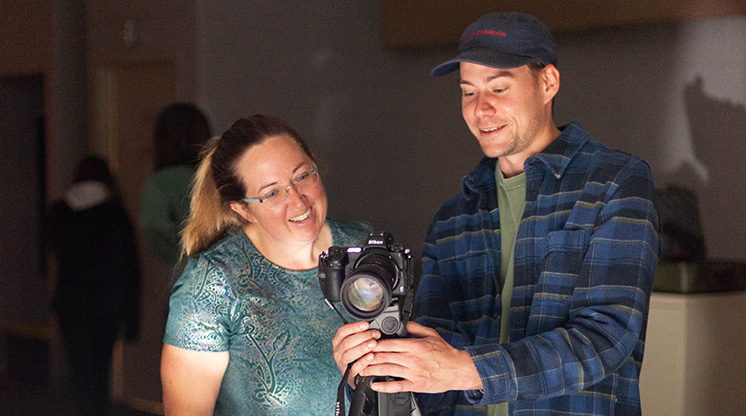 An NMC visual communications instructor and student set up a camera for a photo shoot