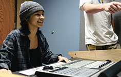AN NMC Audio Technology Program student works on one of the program's high-tech soundboards like the Raven console