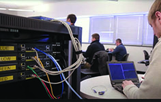 An NMC CIT Infrastructure Program student wires a computer rack