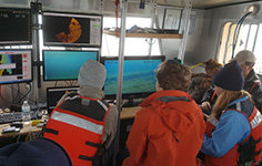 Photo of NMC Marine Technology Program students monitoring equipment aboard the research vessel Northwestern