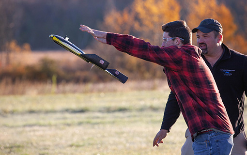 Photo of an NMC UAS Program student launching a drone during a Commercial Drone Operations course