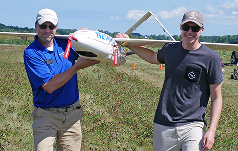 Photo of an NMC UAS Program instructor and student with a large drone at NMC's uncrewed aerial systems training facility
