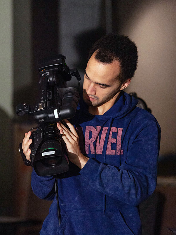 An NMC Visual Communications program student holds a professional video camera