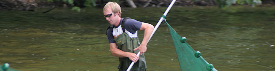 An NMC Environmental Science program student taking samples from a freshwater lake