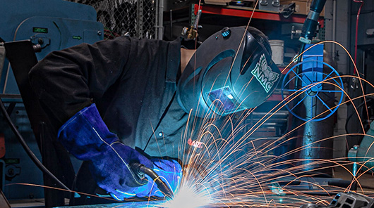 An NMC welding program student practices welding skills