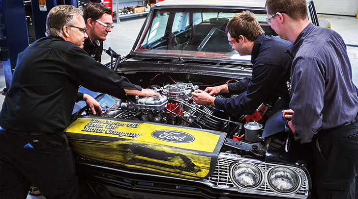 NMC Automotive Technology program students working on a car engine