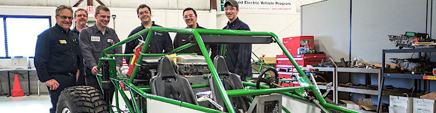 NMC Automotive Technology program students and program coordinator Wayne Moody pose with NMC's entry in the Society of Automotive Engineers' annual Baja endurance race
