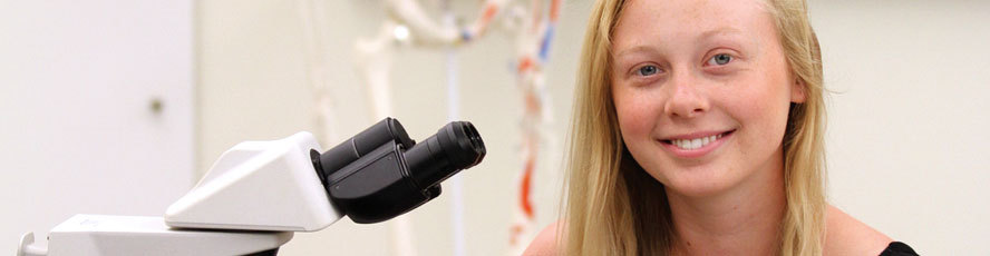 NMC Chemistry program student and microscope