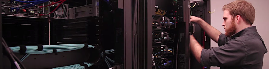 CIT infrastructure and security program student examining networked computers