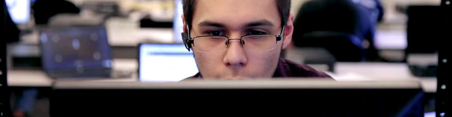 CIT web developer student working on HTML and CSS code while building a website