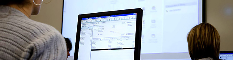 Photo of students and computers in an office administration program class
