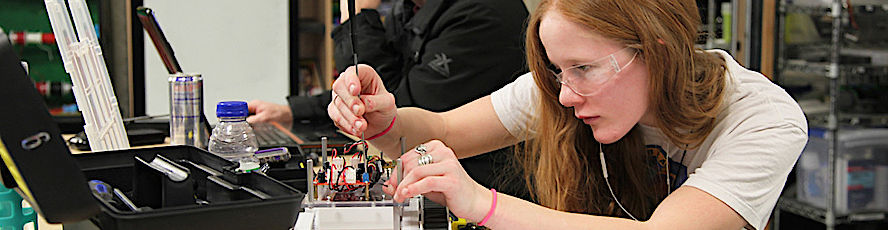 NMC engineering technology program student working on a circuit board