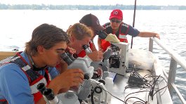 Freshwater Studies students and Constanza Hazelwood with microscopes