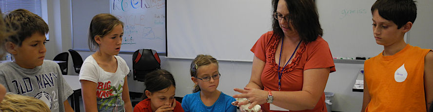 An early childhood education teacher works with young students