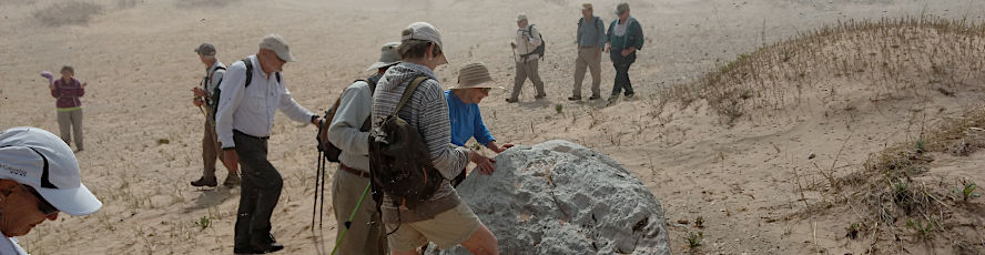 Students examine a boulder in an NMC geology program course