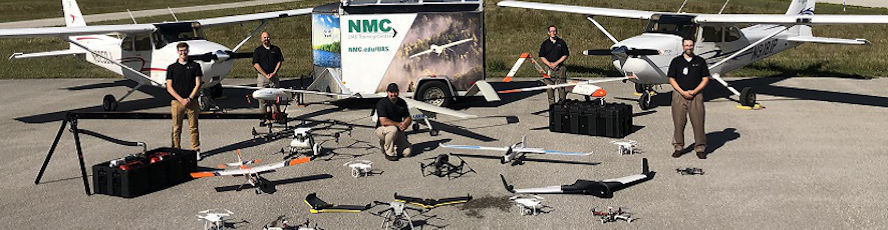 NMC Unmanned Aircraft Systems (UAS) program students and instructors pose with the fleet of drones and unmanned aerial vehicles