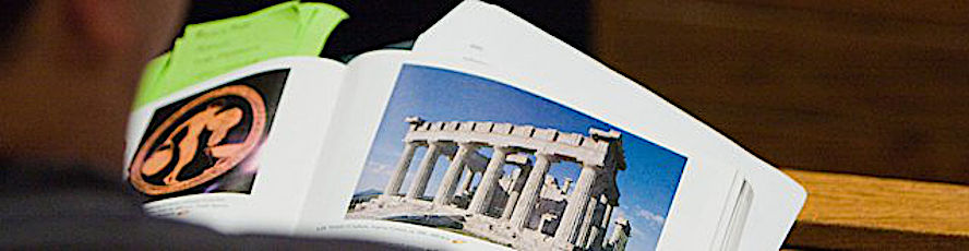 An NMC History Program student looks at a book on ancient Greece