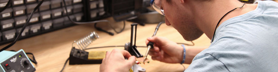 An NMC Manufacturing Technology program student working on a circuit board