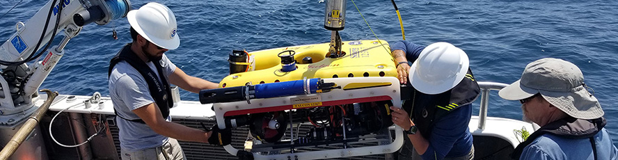 Great Lakes Water Studies Institute students work with a remotely operated vehicle (ROV) aboard the Northwestern research vessel